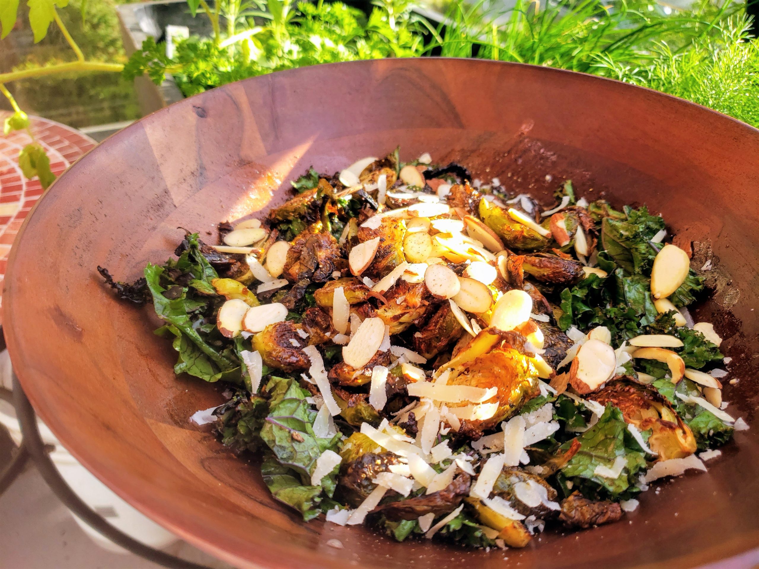 kale salad with brussels sprouts in a wooden bowl